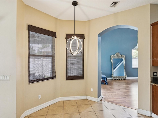 4481 Birchfield Loop, Spring Hill, FL 34609 - unfurnished dining area featuring arched walkways and light tile patterned floors