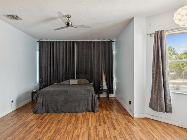 4481 Birchfield Loop, Spring Hill, FL 34609 - bedroom featuring wood finished floors, ceiling fan, and a textured ceiling