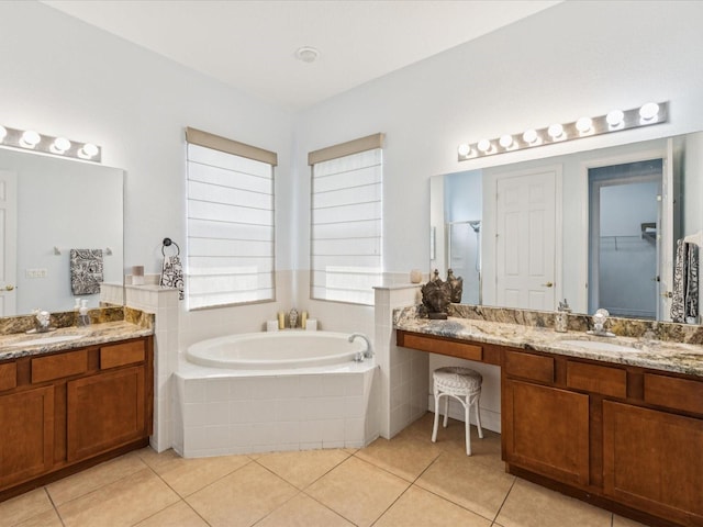4481 Birchfield Loop, Spring Hill, FL 34609 - bathroom featuring a garden tub, tile patterned floors, two vanities, and a spacious closet
