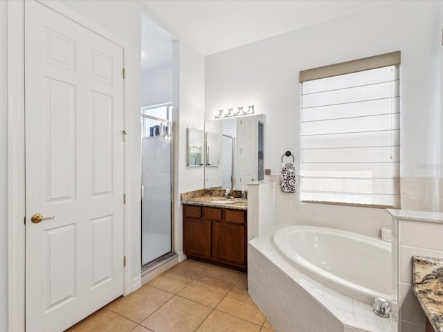 4481 Birchfield Loop, Spring Hill, FL 34609 - bathroom with vanity, a bath, a stall shower, tile patterned flooring, and plenty of natural light