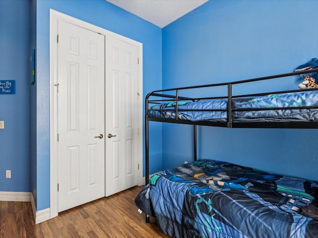 4481 Birchfield Loop, Spring Hill, FL 34609 - bedroom featuring wood finished floors and baseboards