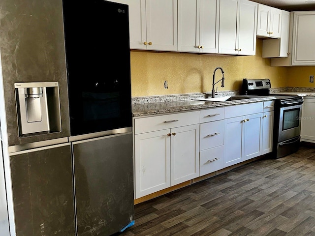 723 W Bayshore Dr, Tarpon Springs, FL 34689 - kitchen with fridge with ice dispenser, electric range, dark wood-style floors, and white cabinets