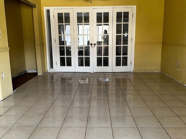 723 W Bayshore Dr, Tarpon Springs, FL 34689 - tiled spare room featuring french doors and baseboards