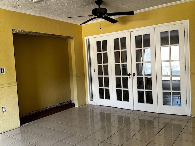 723 W Bayshore Dr, Tarpon Springs, FL 34689 - tiled spare room featuring french doors, a ceiling fan, a textured ceiling, and crown molding