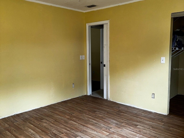 723 W Bayshore Dr, Tarpon Springs, FL 34689 - spare room with ornamental molding and dark wood-style floors