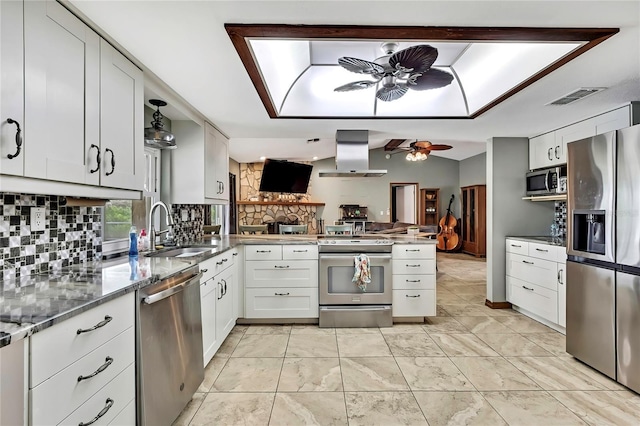 364 Waterfall Dr, Spring Hill, FL 34608 - kitchen featuring appliances with stainless steel finishes, island exhaust hood, a peninsula, tasteful backsplash, and ceiling fan