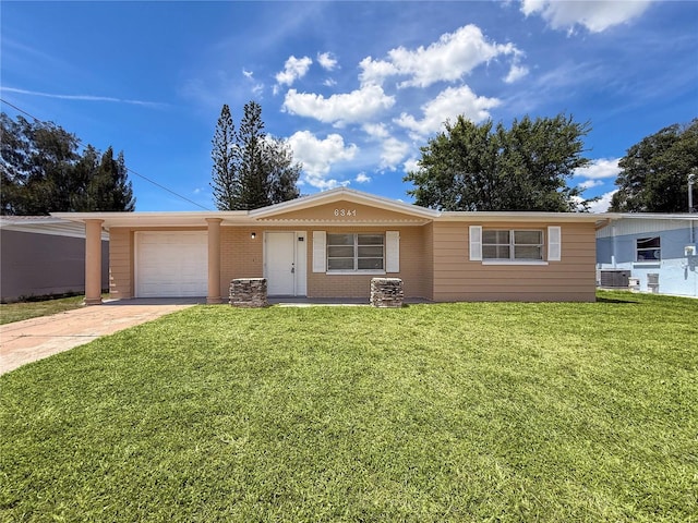 6341 Hyperion Dr, Port Richey, FL 34668 - ranch-style house featuring driveway, a front lawn, a garage, and brick siding