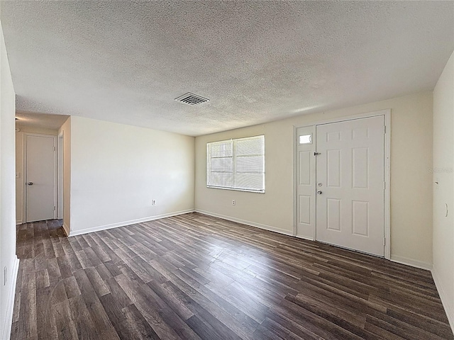6341 Hyperion Dr, Port Richey, FL 34668 - entryway featuring dark wood-type flooring and a textured ceiling