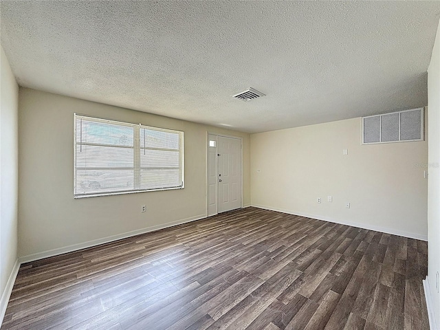 6341 Hyperion Dr, Port Richey, FL 34668 - spare room with wood finished floors and a textured ceiling