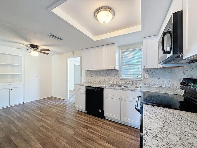 6341 Hyperion Dr, Port Richey, FL 34668 - kitchen with black appliances, backsplash, a raised ceiling, and white cabinetry