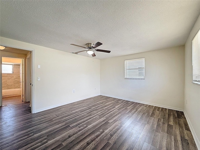 6341 Hyperion Dr, Port Richey, FL 34668 - empty room featuring dark wood-type flooring, ceiling fan, healthy amount of natural light, and a textured ceiling