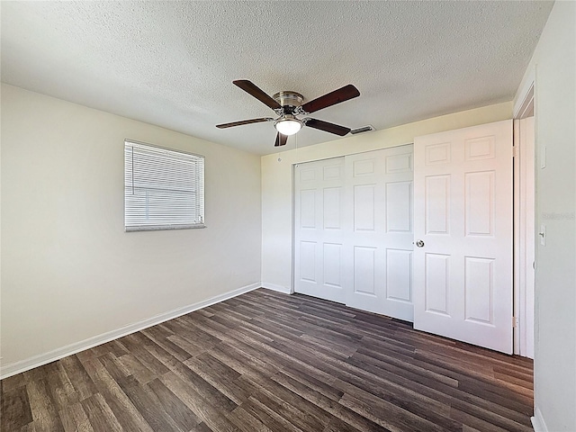 6341 Hyperion Dr, Port Richey, FL 34668 - unfurnished bedroom featuring dark wood-type flooring, a textured ceiling, a closet, and ceiling fan