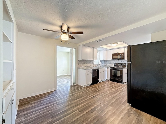 6341 Hyperion Dr, Port Richey, FL 34668 - kitchen featuring black appliances, wood finished floors, a ceiling fan, decorative backsplash, and white cabinets