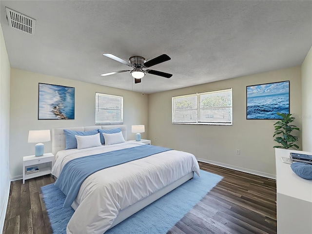 6341 Hyperion Dr, Port Richey, FL 34668 - bedroom with dark wood-type flooring, a textured ceiling, and a ceiling fan