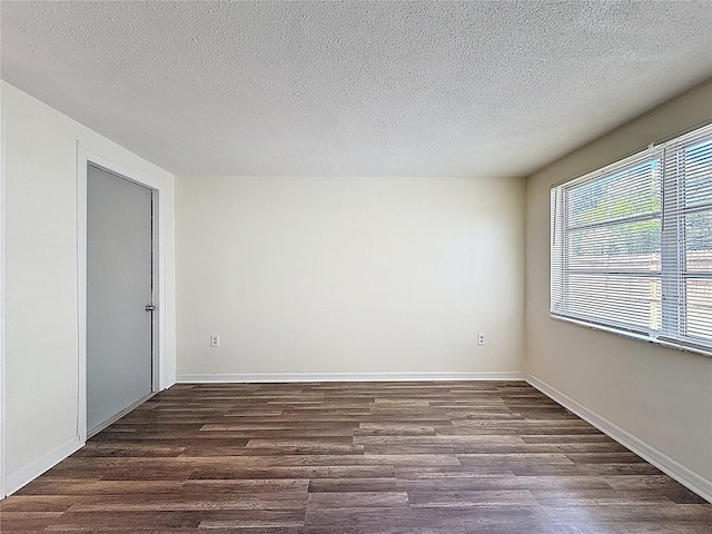 6341 Hyperion Dr, Port Richey, FL 34668 - empty room with dark wood finished floors and a textured ceiling