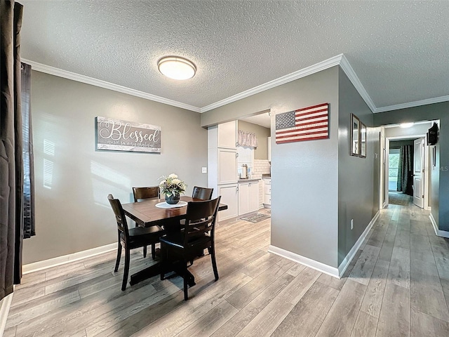 11722 Carissa Ln Unit 49A, New Port Richey, FL 34654 - dining room with light wood-type flooring, a textured ceiling, and ornamental molding