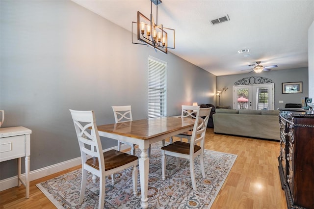 3450 Ferrell St, New Port Richey, FL 34655 - dining area with light wood-style flooring, ceiling fan, and a chandelier