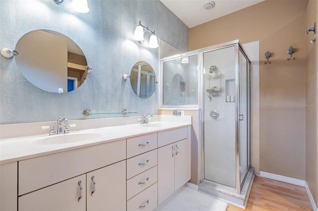 3450 Ferrell St, New Port Richey, FL 34655 - full bath with a stall shower, double vanity, and wood finished floors
