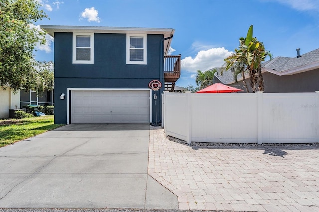 3450 Ferrell St, New Port Richey, FL 34655 - view of front of home featuring an attached garage, driveway, and stucco siding