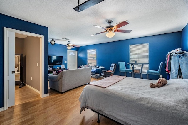 3450 Ferrell St, New Port Richey, FL 34655 - bedroom with a textured ceiling, wood finished floors, and ceiling fan
