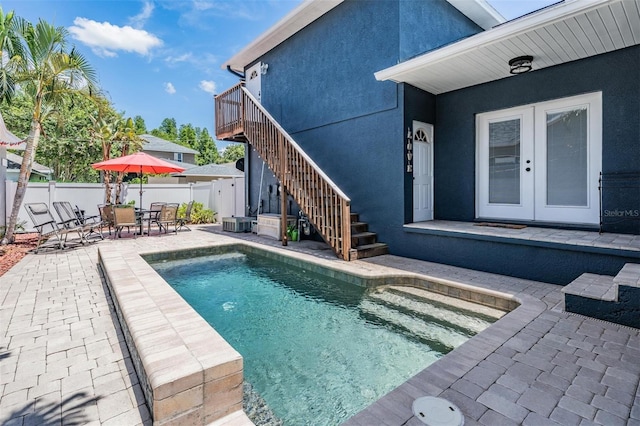3450 Ferrell St, New Port Richey, FL 34655 - view of pool with stairway, a fenced backyard, a patio, french doors, and a wooden deck