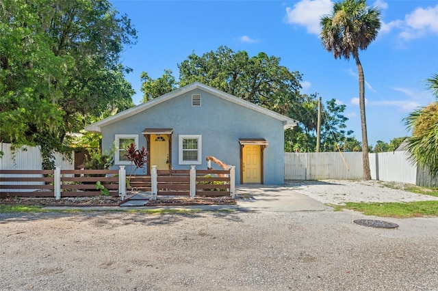 5724 Casson Ave, New Port Richey, FL 34652 - bungalow-style house featuring stucco siding and a fenced front yard