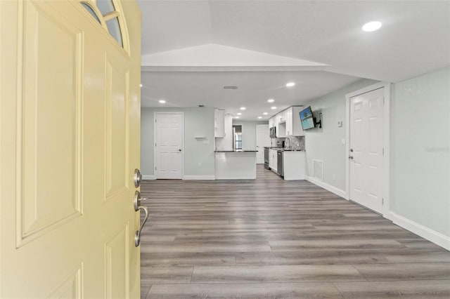 5724 Casson Ave, New Port Richey, FL 34652 - entrance foyer featuring recessed lighting, wood finished floors, and lofted ceiling