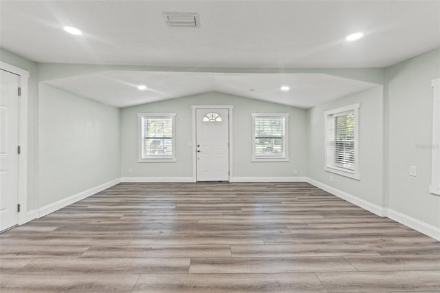 5724 Casson Ave, New Port Richey, FL 34652 - foyer entrance featuring lofted ceiling, wood finished floors, plenty of natural light, and recessed lighting
