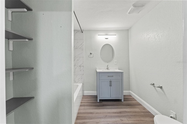 5724 Casson Ave, New Port Richey, FL 34652 - bathroom with vanity, wood finished floors, bathing tub / shower combination, and a textured ceiling