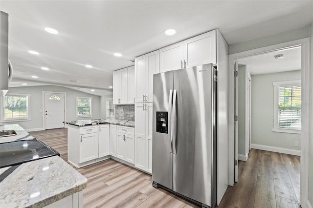 5724 Casson Ave, New Port Richey, FL 34652 - kitchen with stainless steel refrigerator with ice dispenser, light wood finished floors, a peninsula, white cabinetry, and recessed lighting