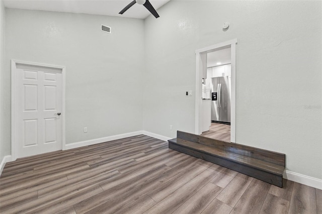 5724 Casson Ave, New Port Richey, FL 34652 - empty room featuring a ceiling fan, wood finished floors, and a towering ceiling