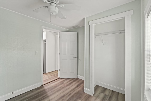5724 Casson Ave, New Port Richey, FL 34652 - unfurnished bedroom featuring wood finished floors, a closet, and a ceiling fan