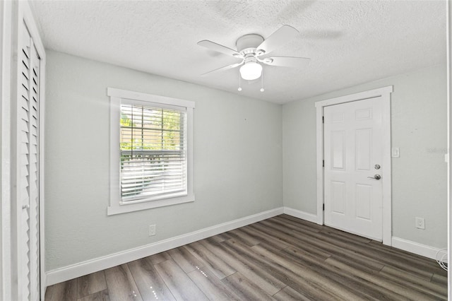 5724 Casson Ave, New Port Richey, FL 34652 - unfurnished bedroom featuring dark wood finished floors, a textured ceiling, and ceiling fan