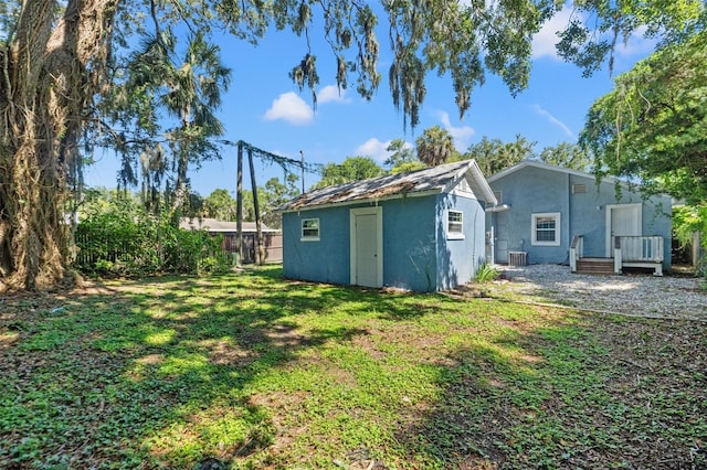 5724 Casson Ave, New Port Richey, FL 34652 - view of grassy yard with an outdoor structure and a deck