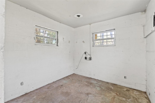 5724 Casson Ave, New Port Richey, FL 34652 - empty room with unfinished concrete floors and plenty of natural light