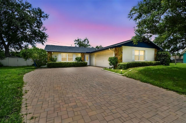 1071 Lexington Ct, Largo, FL 33771 - ranch-style home featuring a garage, decorative driveway, and stucco siding