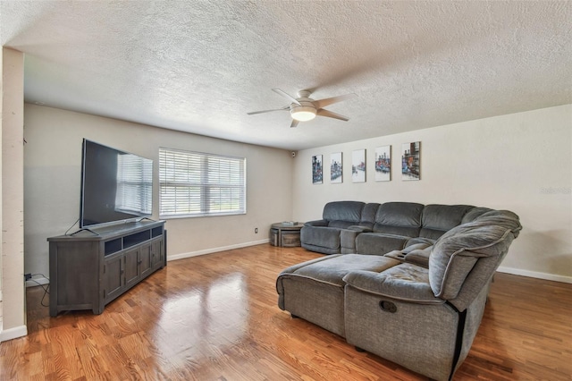 1071 Lexington Ct, Largo, FL 33771 - living room featuring a ceiling fan, light wood-style floors, and a textured ceiling