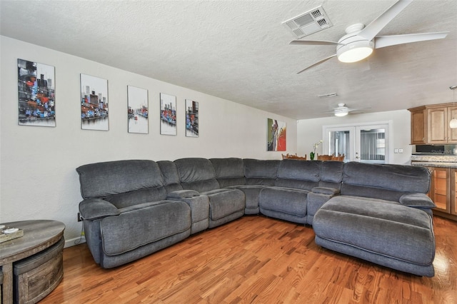 1071 Lexington Ct, Largo, FL 33771 - living area featuring ceiling fan, light wood-type flooring, and a textured ceiling