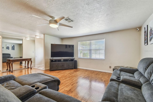 1071 Lexington Ct, Largo, FL 33771 - living room with ceiling fan, light wood-type flooring, and a textured ceiling