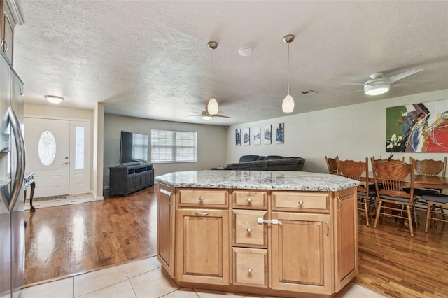 1071 Lexington Ct, Largo, FL 33771 - kitchen with a ceiling fan, a textured ceiling, open floor plan, stainless steel fridge with ice dispenser, and hanging light fixtures