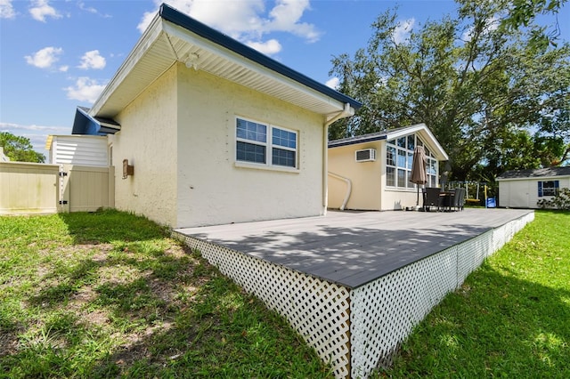 1071 Lexington Ct, Largo, FL 33771 - back of property featuring stucco siding, a wooden deck, and a wall mounted air conditioner