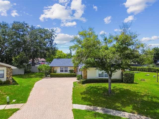 1071 Lexington Ct, Largo, FL 33771 - view of front of property with decorative driveway, a front lawn, and stucco siding