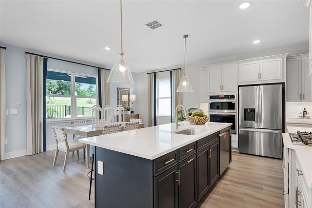 823 Emerald Grove Dr, Apopka, FL 32703 - kitchen with stainless steel appliances, light countertops, plenty of natural light, and recessed lighting