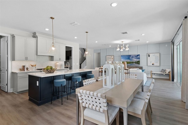 823 Emerald Grove Dr, Apopka, FL 32703 - dining area with wood finished floors, recessed lighting, and a chandelier