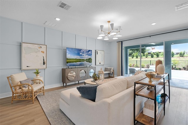 823 Emerald Grove Dr, Apopka, FL 32703 - living room featuring light wood-style floors, a chandelier, and recessed lighting