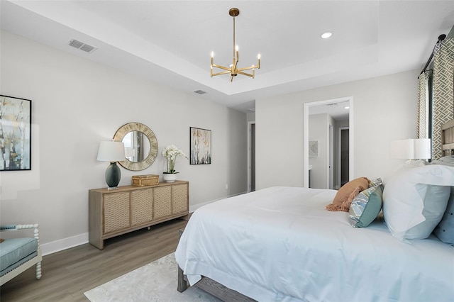 823 Emerald Grove Dr, Apopka, FL 32703 - bedroom featuring wood finished floors, a chandelier, recessed lighting, and a raised ceiling