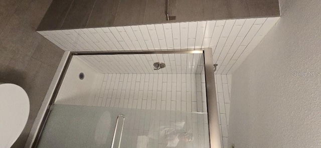 423 E Kaley St, Orlando, FL 32806 - bathroom with a textured wall, a shower, and wood ceiling