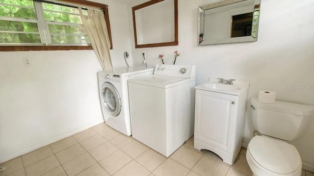 423 E Kaley St, Orlando, FL 32806 - laundry area with washer and clothes dryer and light tile patterned floors