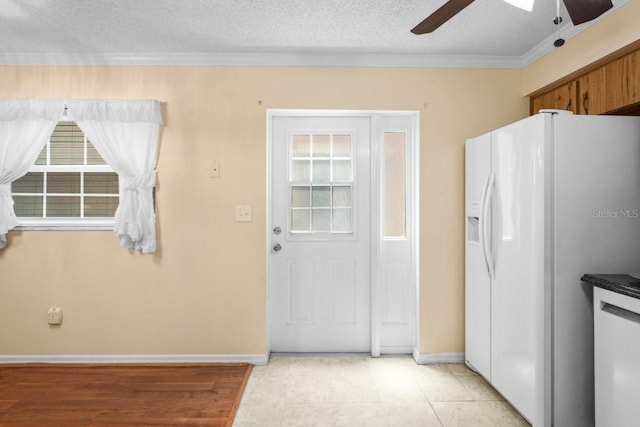 6702 Dartmoor Ln Unit 7A, New Port Richey, FL 34653 - kitchen featuring white fridge with ice dispenser, ceiling fan, ornamental molding, a textured ceiling, and light tile patterned flooring