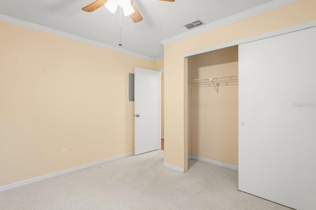 6702 Dartmoor Ln Unit 7A, New Port Richey, FL 34653 - unfurnished bedroom with carpet, a closet, ornamental molding, a textured ceiling, and a ceiling fan